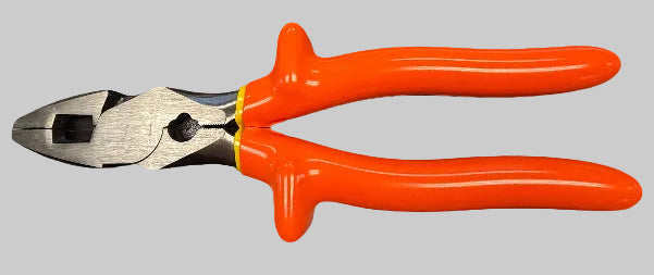 Orange-handled wire cutting pliers resting on a dark tabletop, with a handwritten calendar page and pencil in the background.